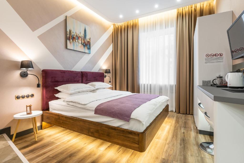 キーウにあるLuteranskaya apartmentsのベッドルーム(紫色のヘッドボード付きのベッド1台付)