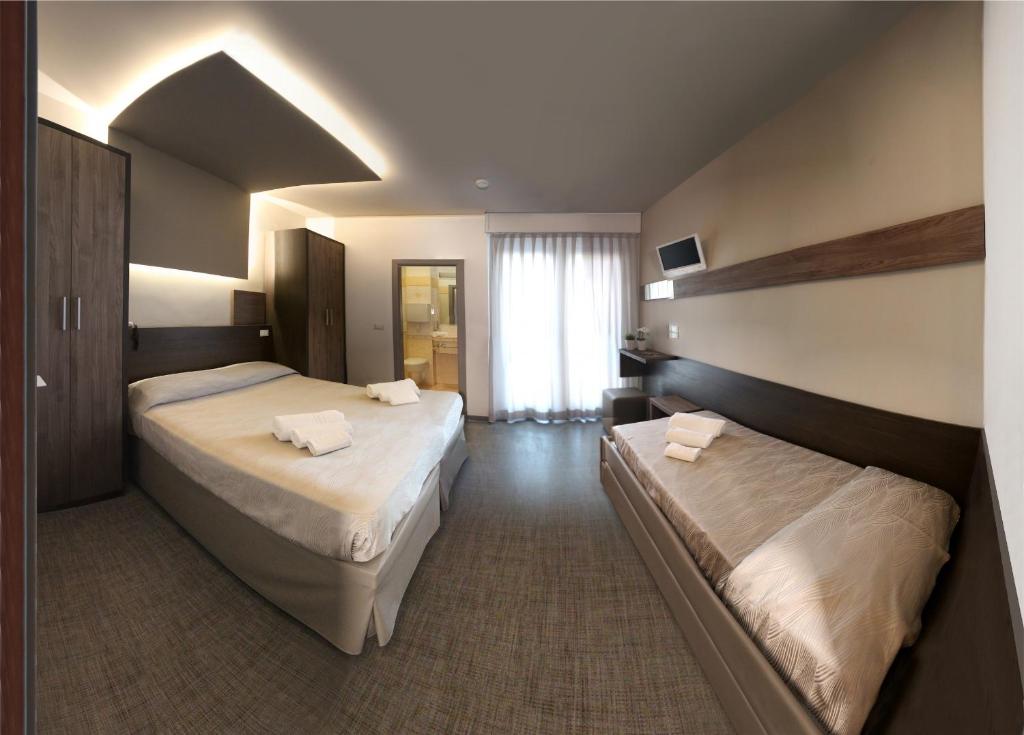 Postel nebo postele na pokoji v ubytování Hotel Continental & Residence