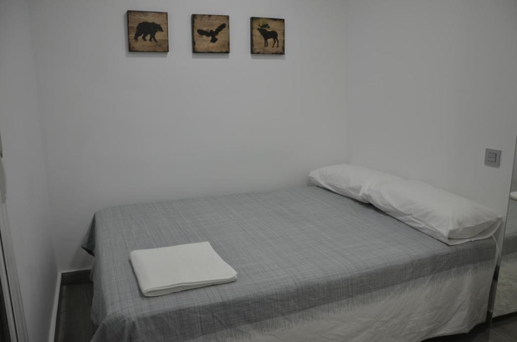 a bedroom with a bed with a laptop on it at CHECK-IN 24H NUEVO Único WIFI FAMILIAR Centro Planta 3 in Zaragoza