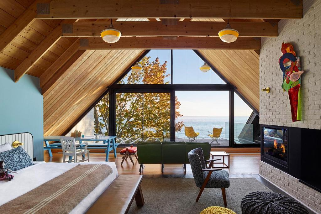 a bedroom with a bed and a large window at Drake Devonshire in Wellington