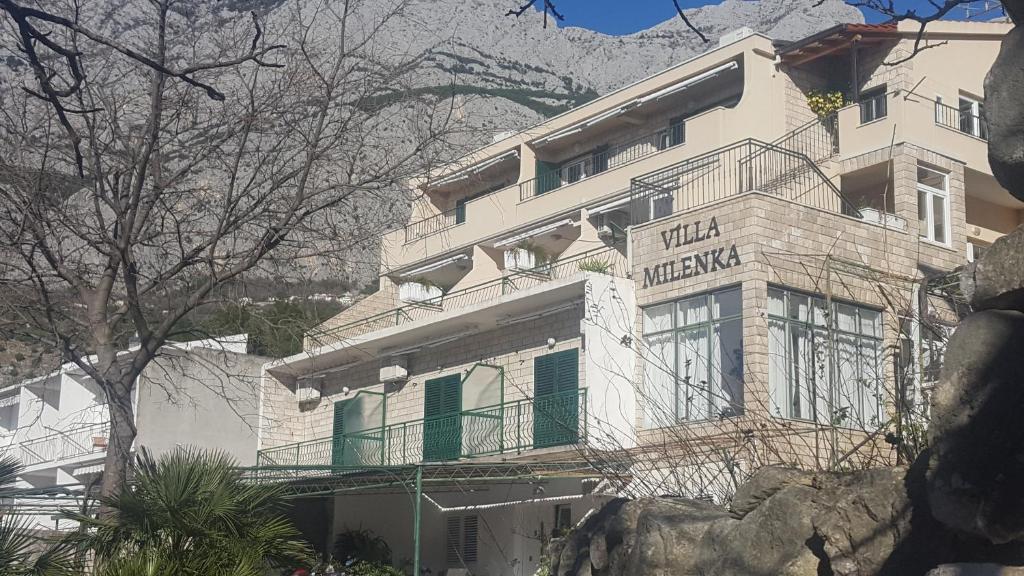 a building with a sign that reads hotel mecca at VILA MILENKA Apartmani Drago in Tučepi