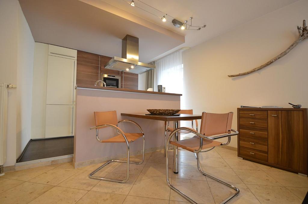 a kitchen with a table and chairs in a room at Strandappartement in Binz in Binz
