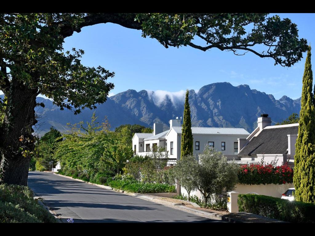 a house on a street with mountains in the background at Sorbonne 1 - No loadshedding in Franschhoek