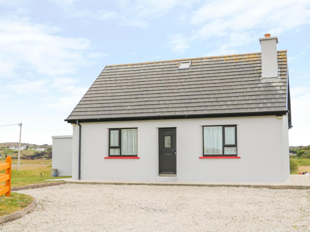 uma casa branca com um telhado preto em Mullaghderg Banks em Letterkenny
