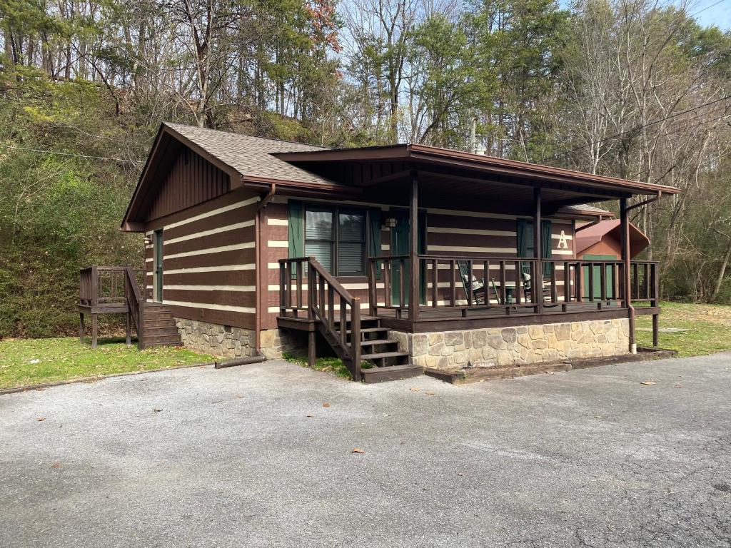 a log cabin with a porch and a deck at On Dolly Time 1 mile from Dollywood in Pigeon Forge