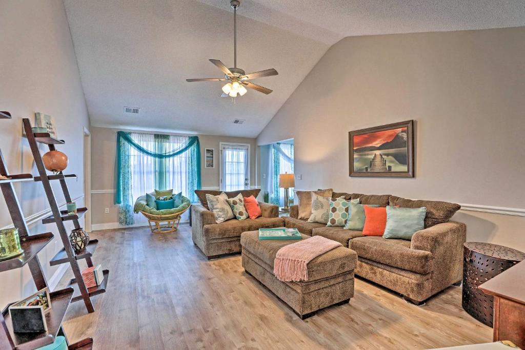 a living room with two couches and a ceiling fan at Beach-Themed Retreat 10 Mi to Downtown Charleston in Charleston