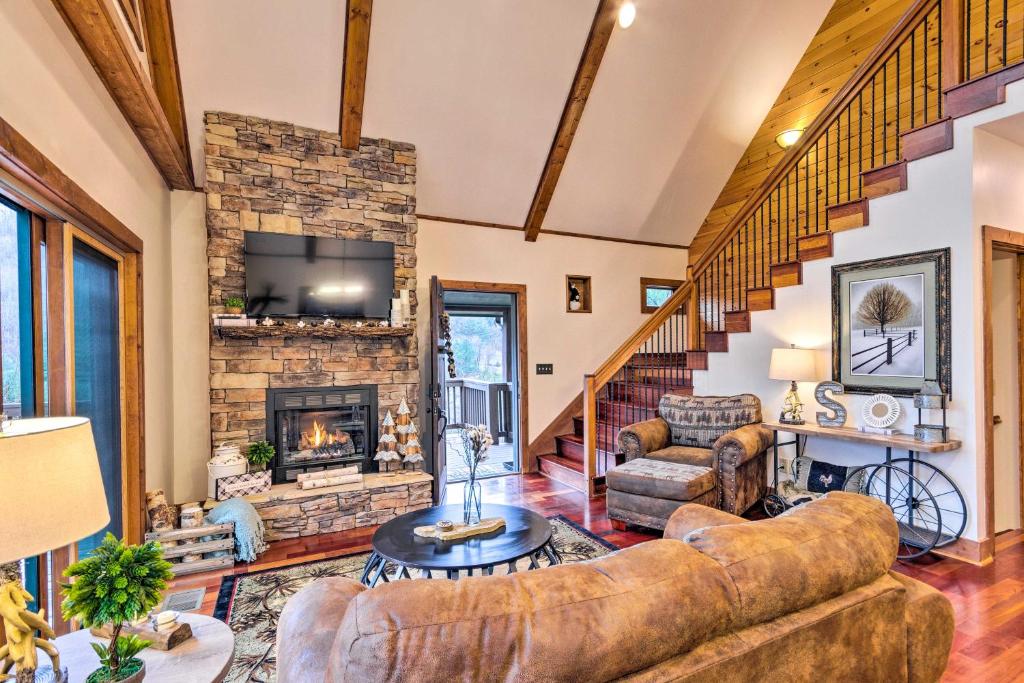 a living room with a couch and a fireplace at Mountain Cabin with Fire Pit, Walk to Golf and Fishing in Vilas