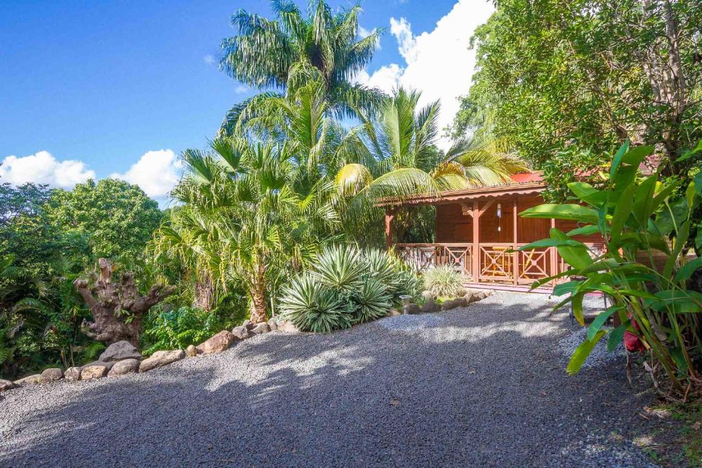 a house with a gravel driveway in front of it at L'Îlot Palmiers in Pointe-Noire