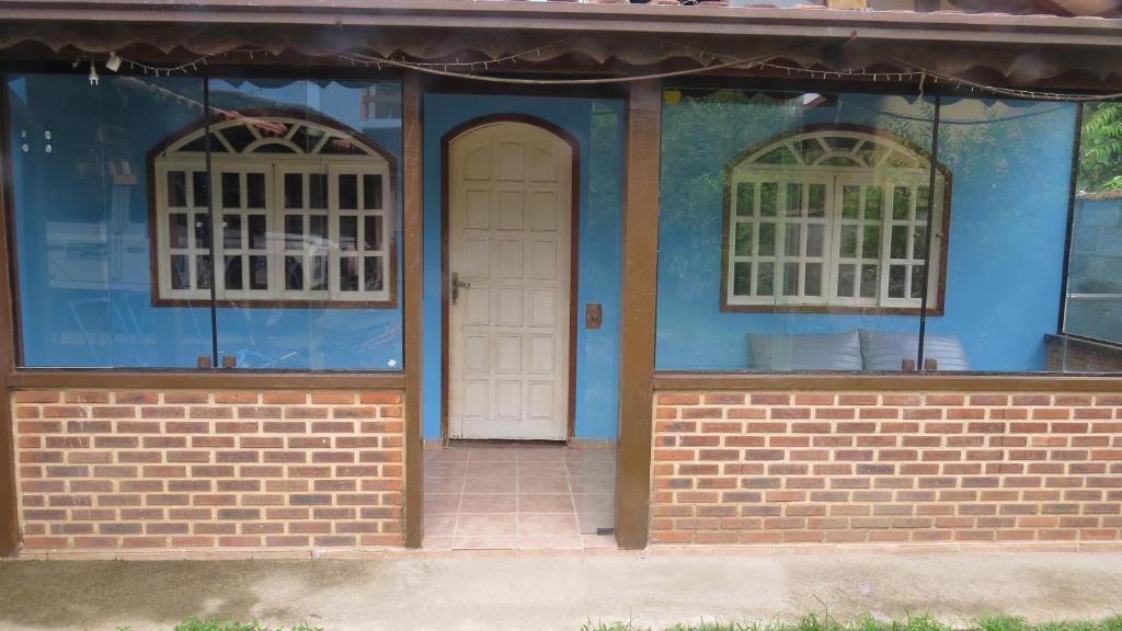 a blue house with two white doors and windows at Blue House in Lumiar