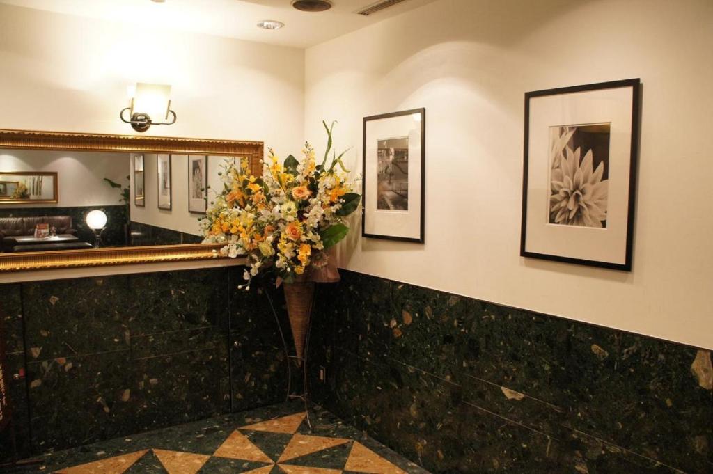 a lobby with a mirror and a vase of flowers at Hotel Abest Meguro / Vacation STAY 71400 in Tokyo