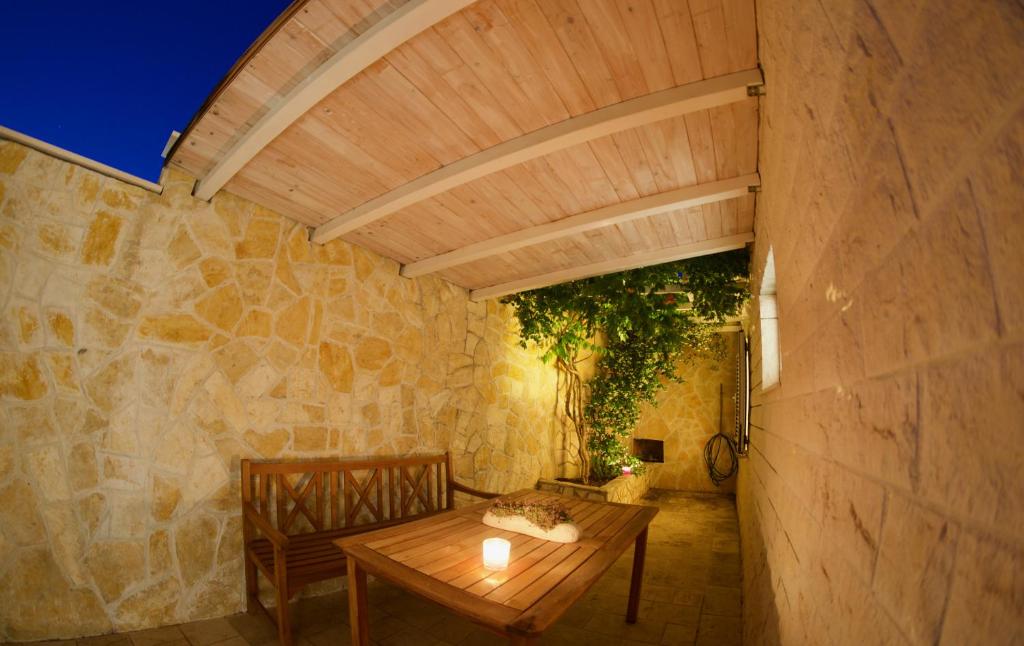 a dining room with a table and a stone wall at Bed and Breakfast BLUE in BLUE in Komiža