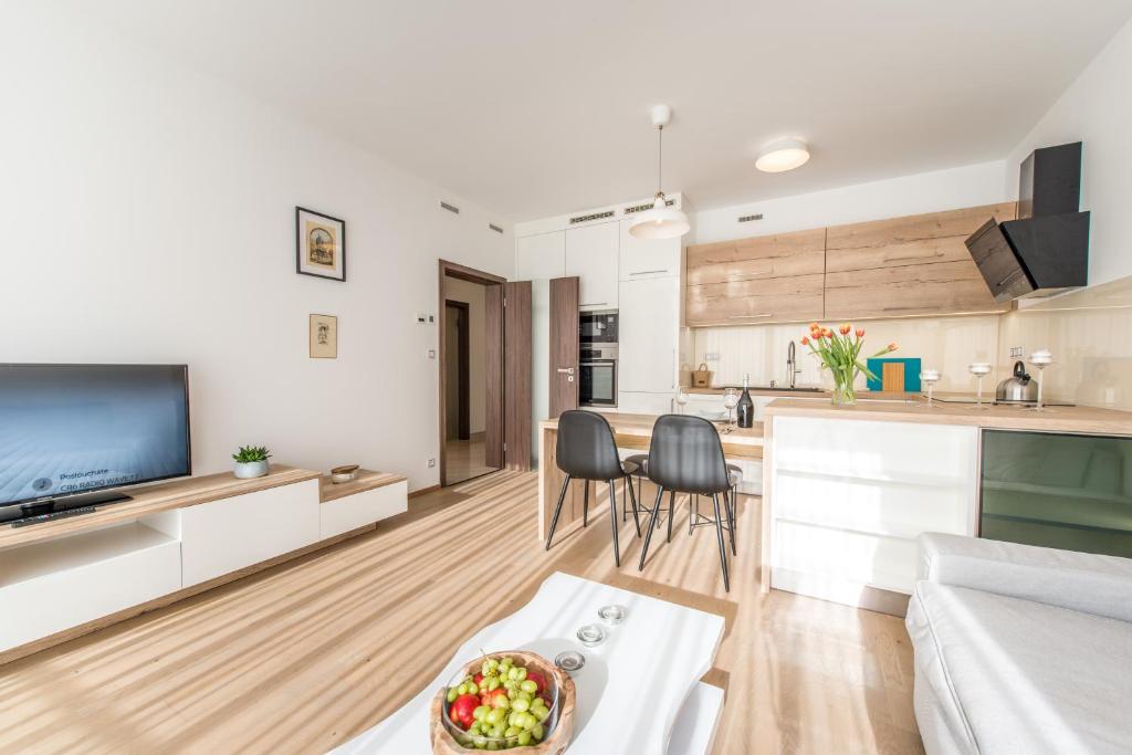 a kitchen and living room with a couch and a table at Mozart Central Apartments with garage in Prague