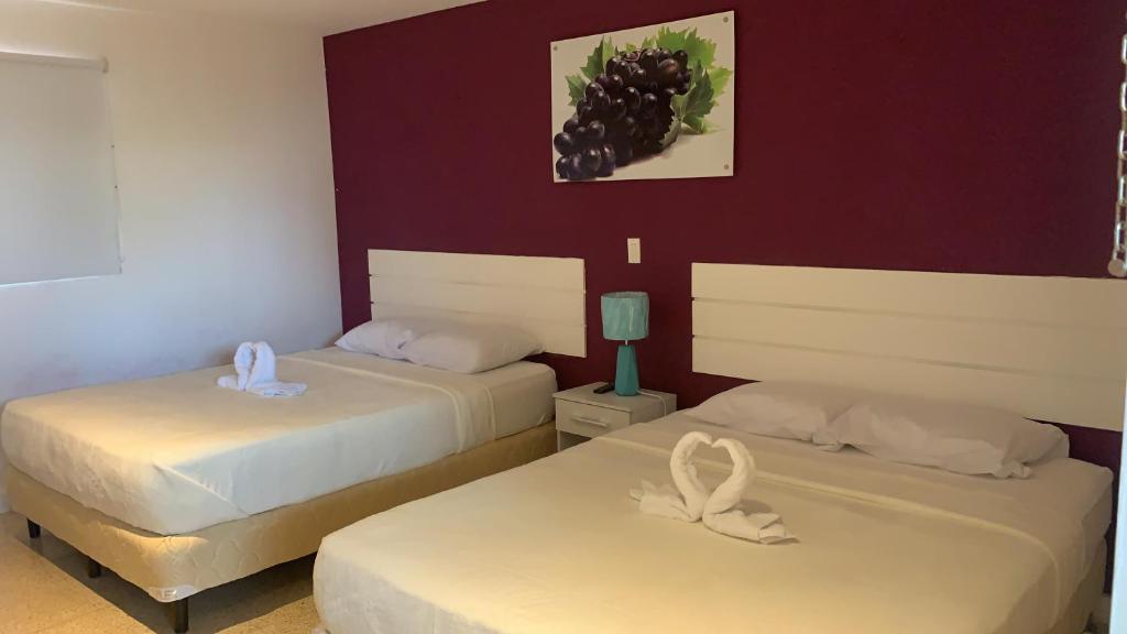 Postel nebo postele na pokoji v ubytování Hostal Familiar Carmencita