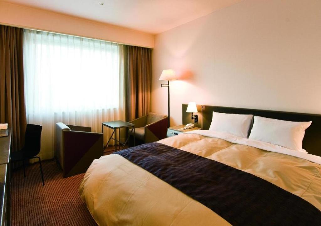a hotel room with a bed and a window at Ogaki Forum Hotel / Vacation STAY 72179 in Ogaki