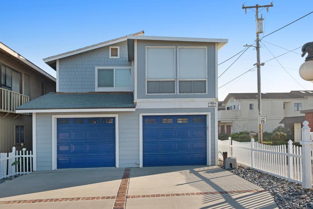 a house with two garage doors in a driveway at Coastal Sun and Fun in Oceano