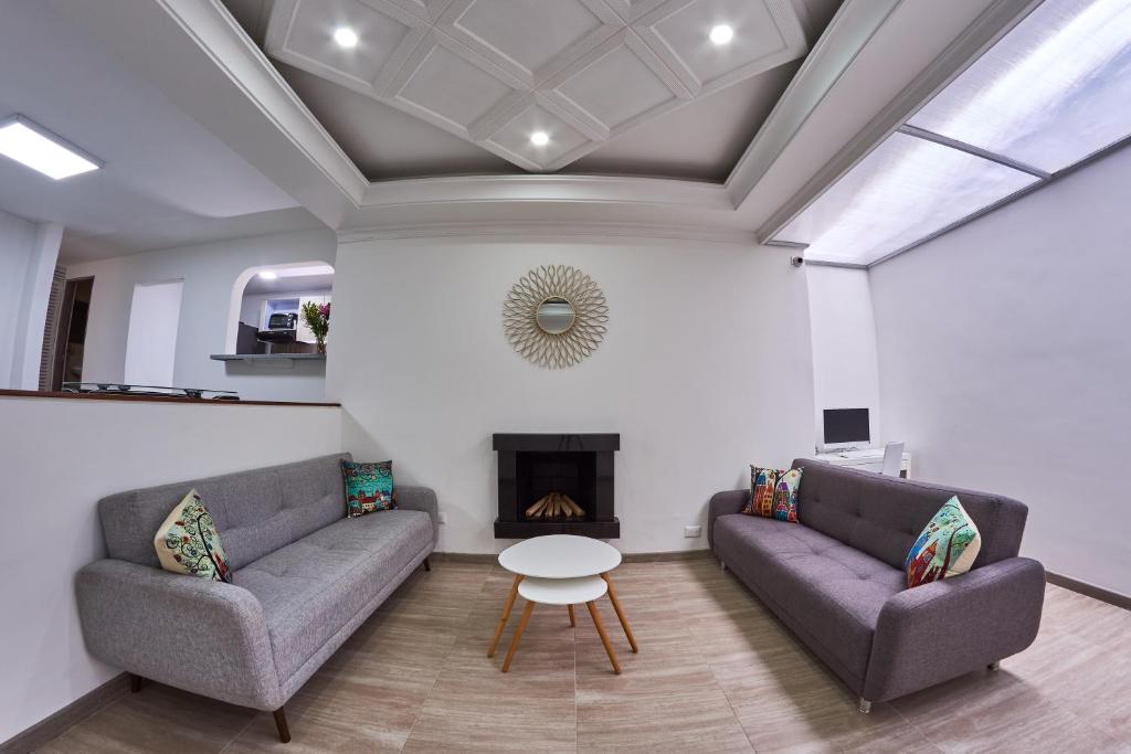 a living room with two couches and a fireplace at Mr. Huésped in Bogotá