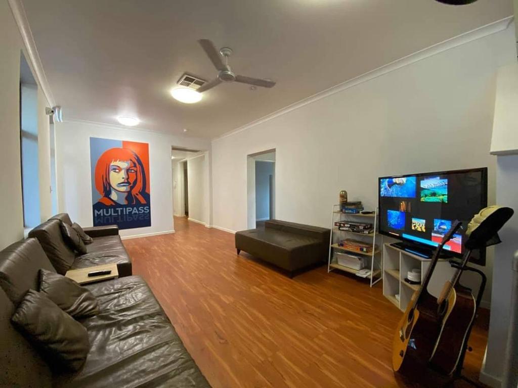 a living room with a couch and a flat screen tv at Downtown Backpackers Hostel Perth - note - Valid Passport required for check in in Perth