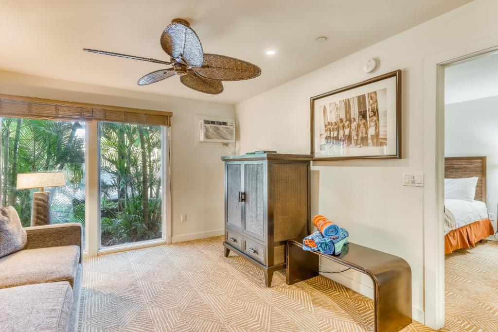 a bedroom with a bed and a ceiling fan at Aina Nalu in Lahaina