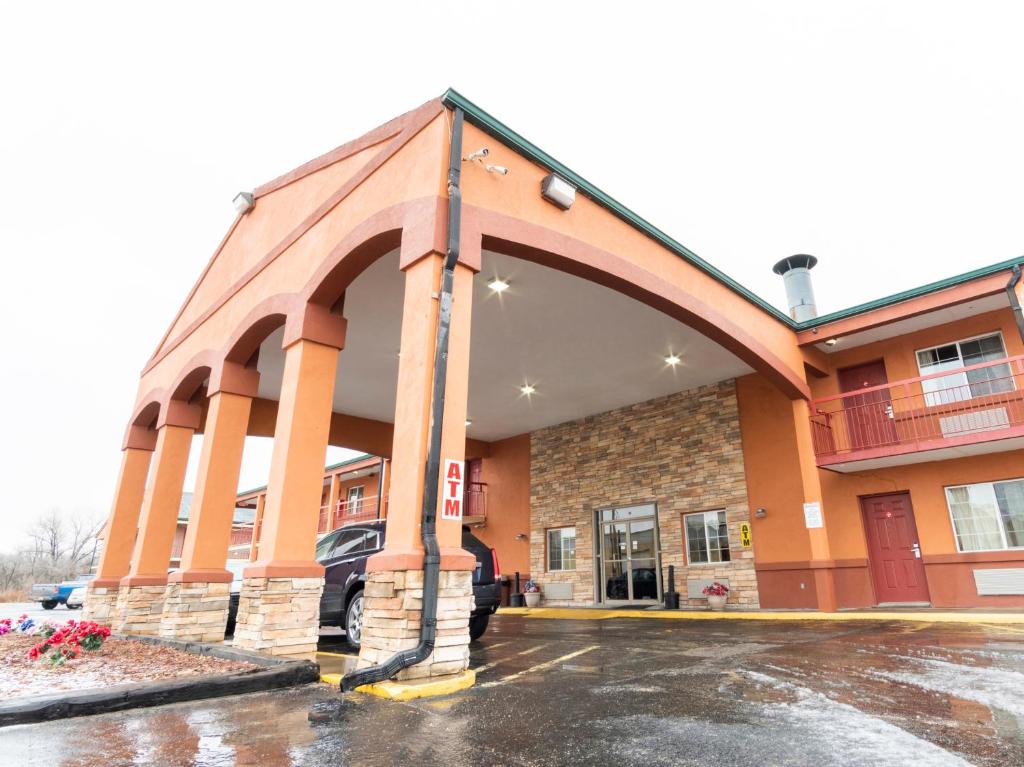 an empty parking lot in front of a building at Budget host inn in Salina