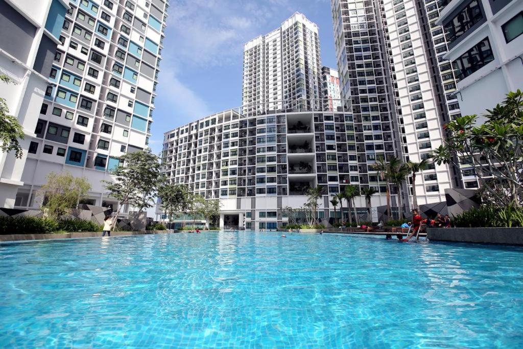 a large swimming pool in a city with tall buildings at I-City Shah Alam by BeeStay Management in Shah Alam