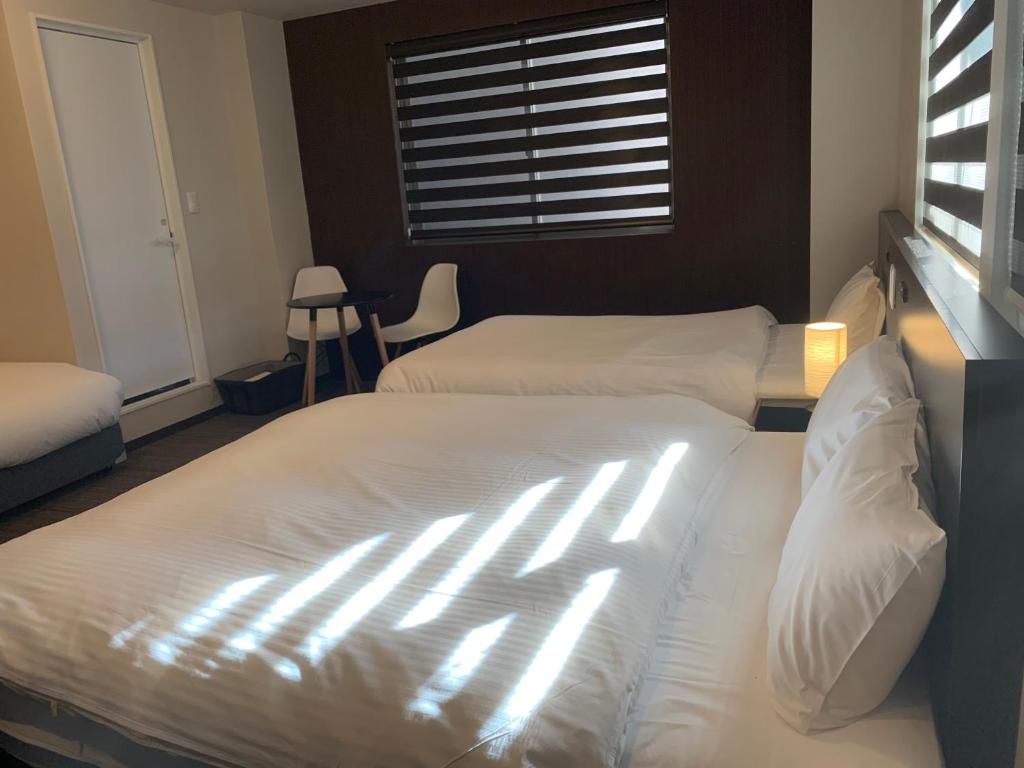 Postel nebo postele na pokoji v ubytování Hotel Kojan