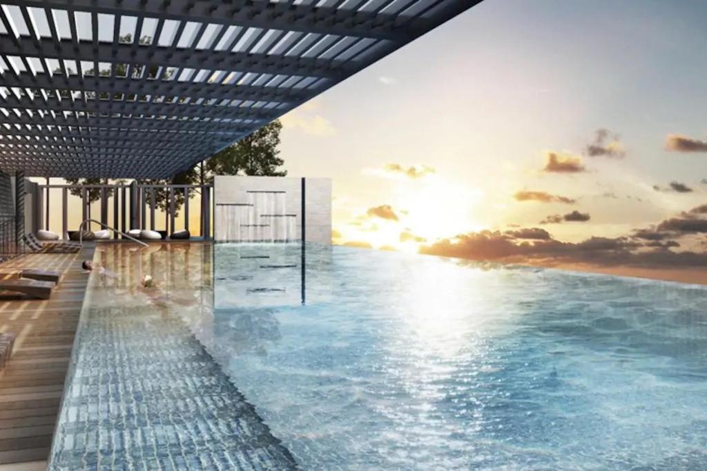 a rendering of a swimming pool with the sun setting at Suria Jelutong Studio by BeeStay in Shah Alam