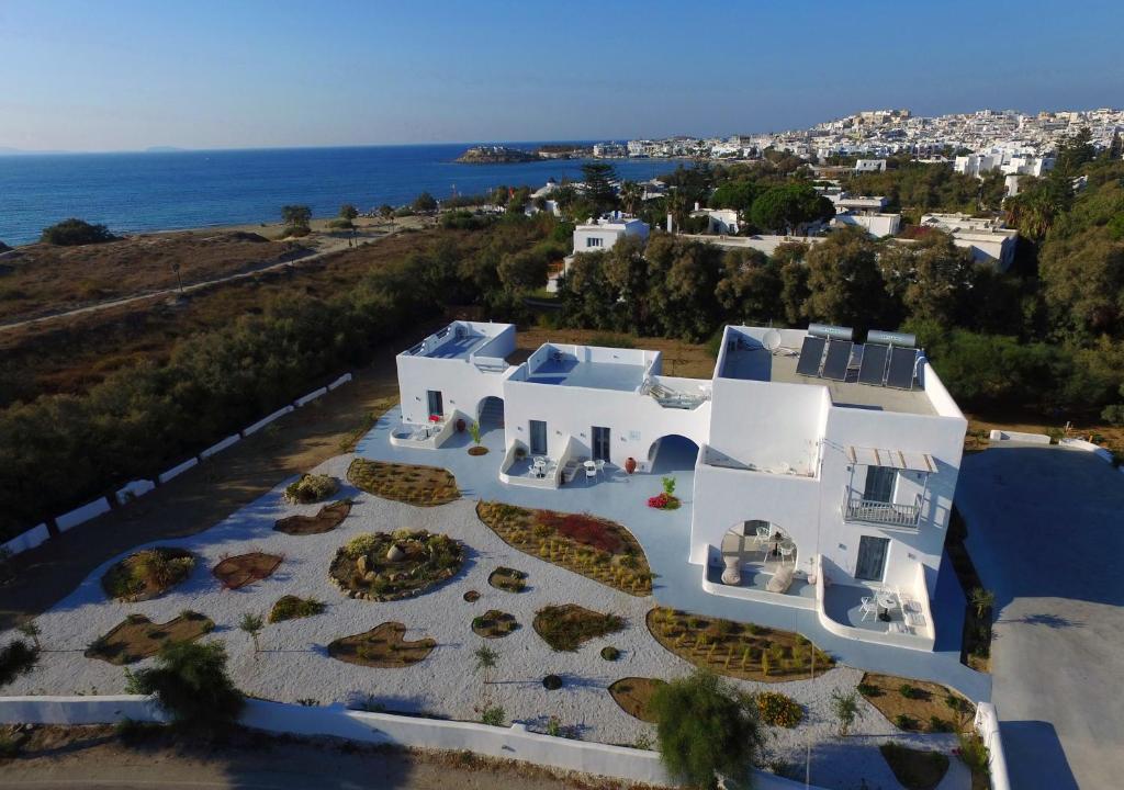 an aerial view of a white building with the ocean at Crystal Mare Suites in Naxos Chora