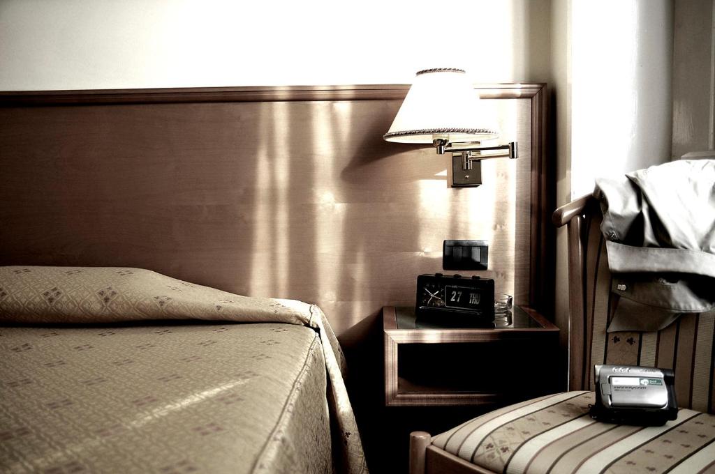 Postel nebo postele na pokoji v ubytování Hotel Estense