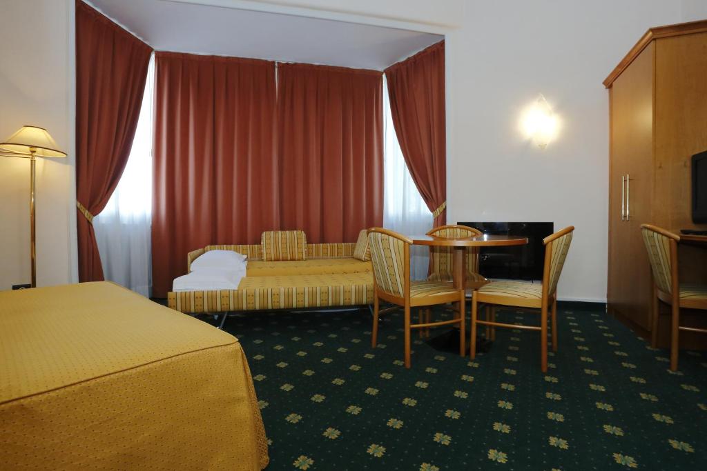 Postel nebo postele na pokoji v ubytování Hotel Estense