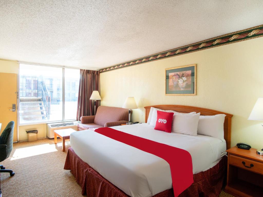 a hotel room with a large bed and a large window at OYO Hotel Oklahoma City South I-35 and SE 29th in Oklahoma City
