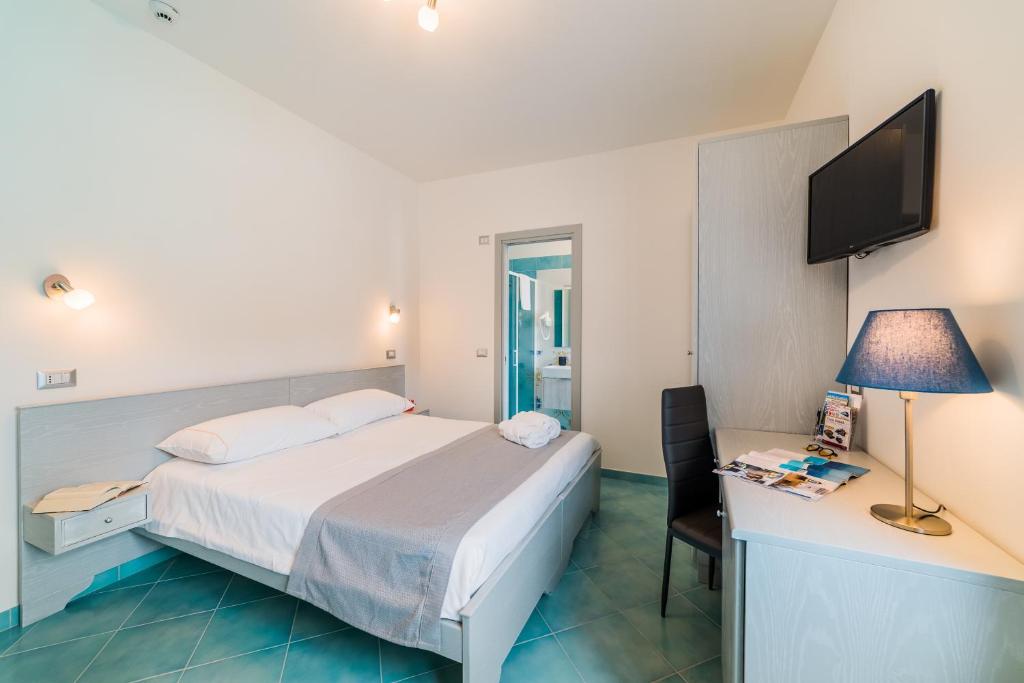 Postel nebo postele na pokoji v ubytování Hotel Corallo Circeo
