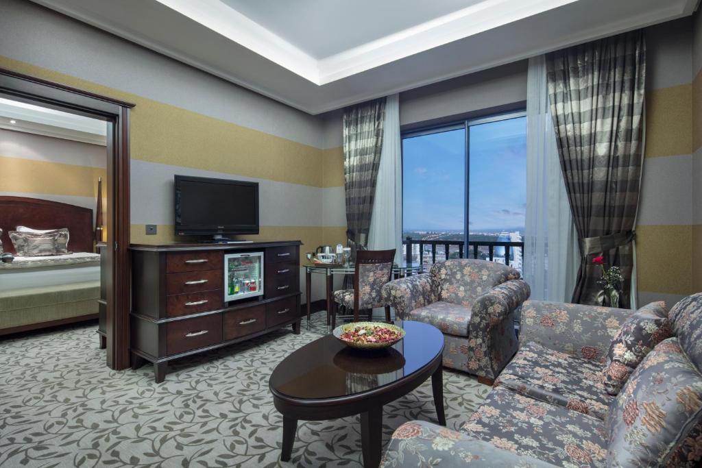 a living room with a couch and a tv at Merit Lefkosa Hotel & Casino in North Nicosia