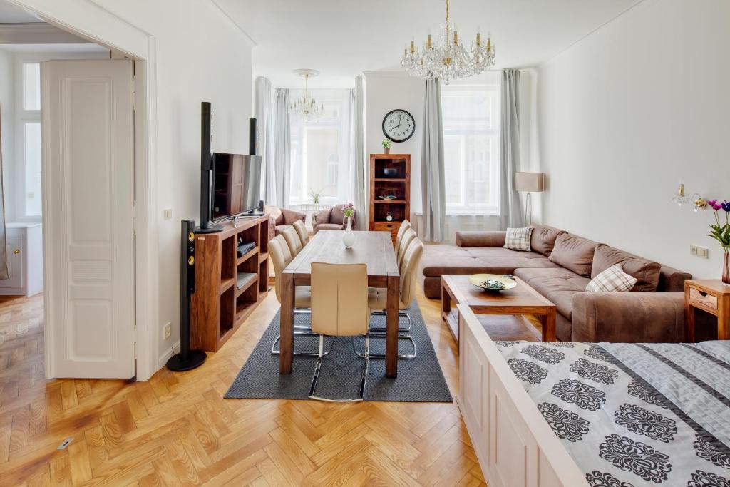 a living room with a couch and a table in it at Old Town Square Apartments in Prague
