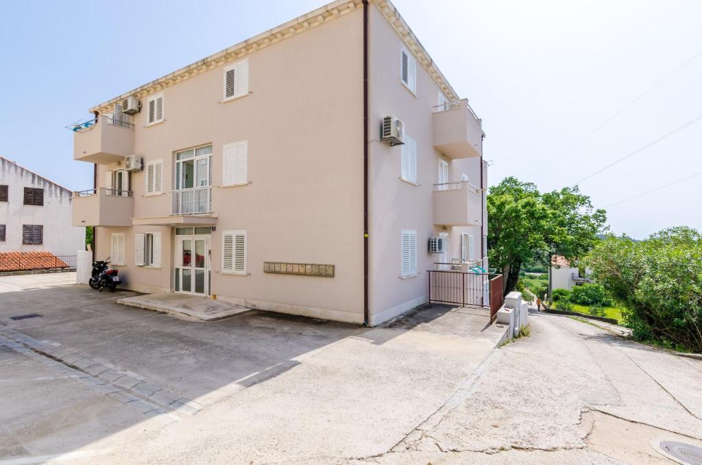 an empty parking lot next to a building at Ana Apartment in Cavtat