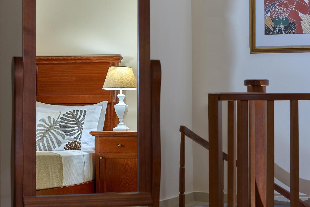 a bedroom with a bed with a lamp on a night stand at Vasia Resort & Spa in Sisi