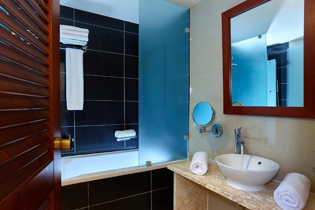 a bathroom with a sink and a mirror at Vasia Resort & Spa in Sisi