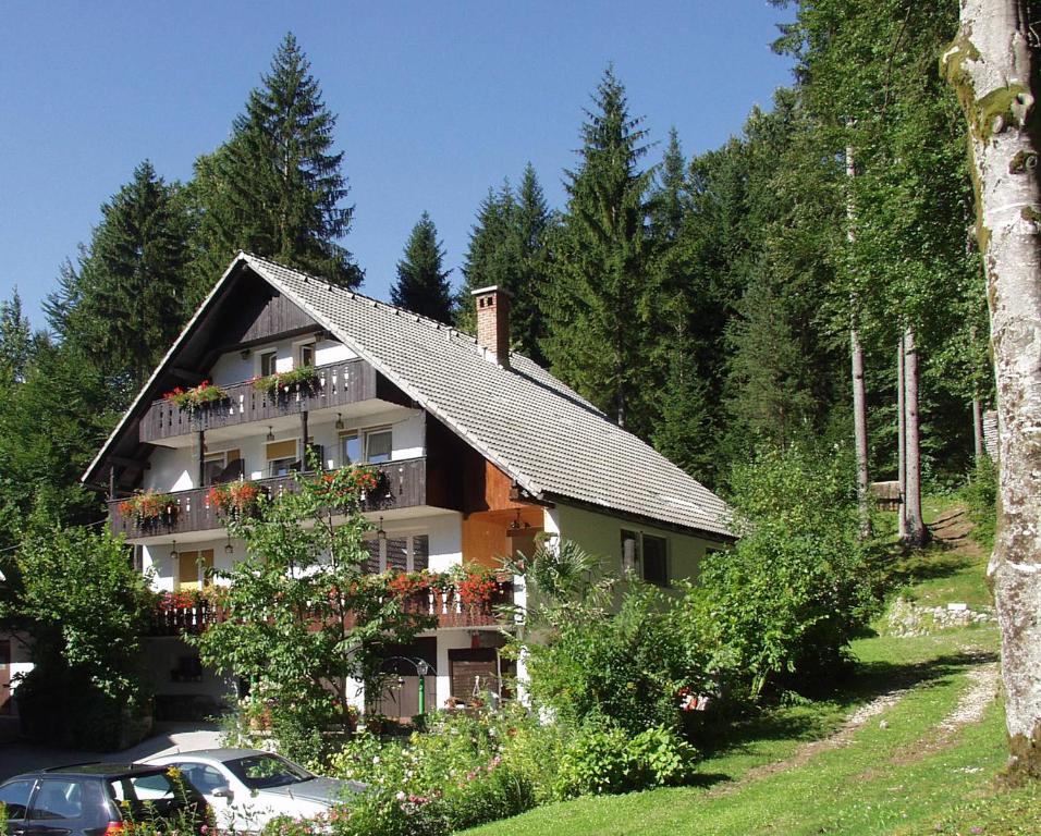 a house with balconies on the side of it at Accommodation Destina, LAKE BOHINJ in Bohinj