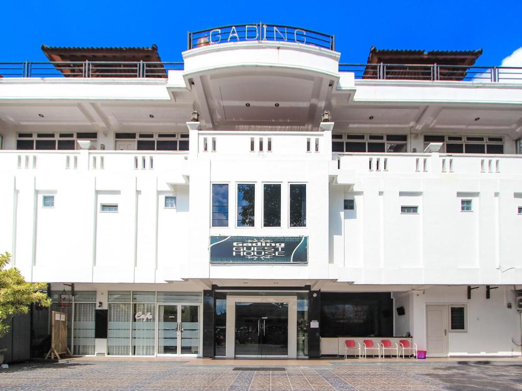 a large white building with a sign on it at Gading Guest House in Mataram