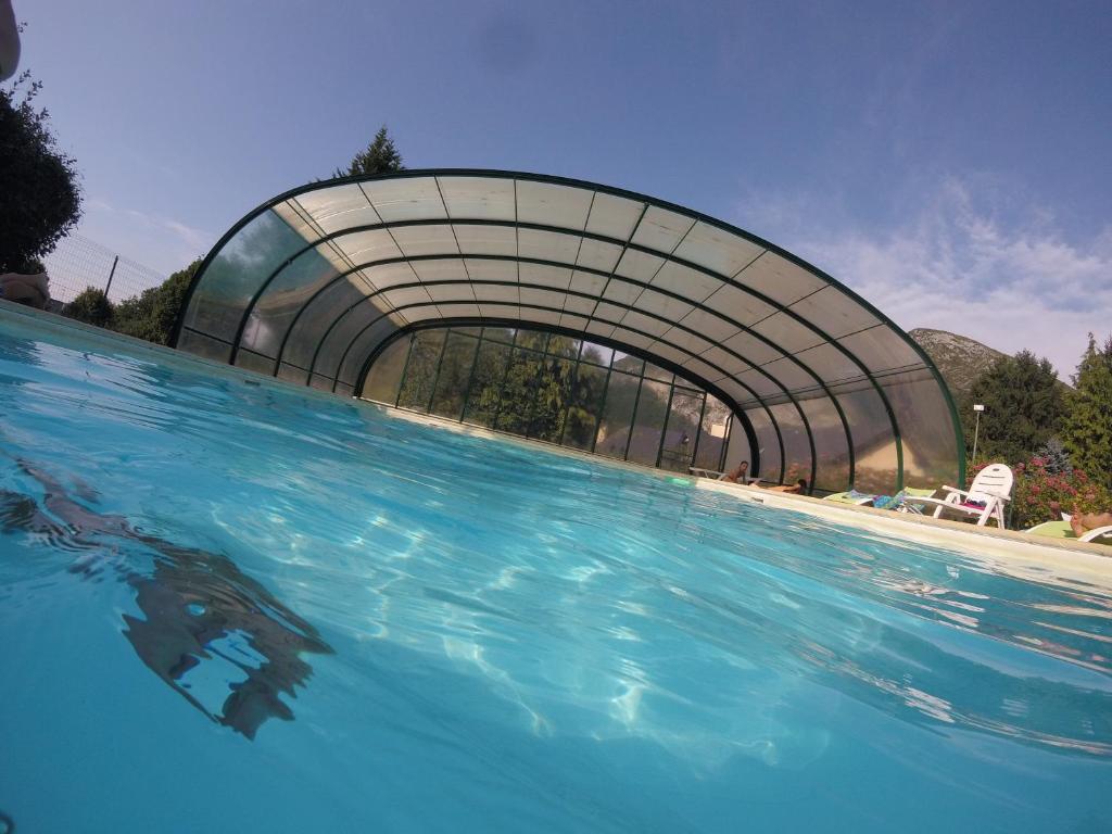 a large swimming pool with a building in the background at Les Gentianes in Aspin-en-Lavedan