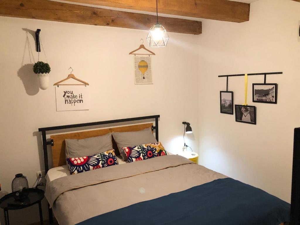 a bedroom with a bed with pillows on it at The Top House in Braşov