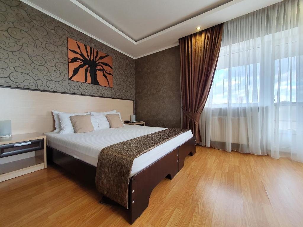 a hotel room with a bed and a large window at Art Hotel in Krasnodar