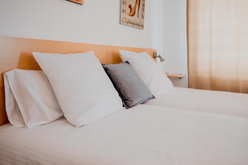 a white bed with white pillows on it at Sol Tarter 4-7 in El Tarter