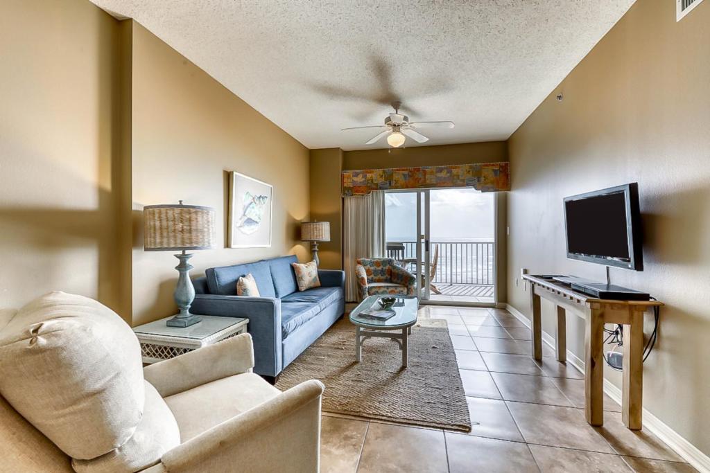 a living room with a couch and a tv at Tidewater II in Orange Beach