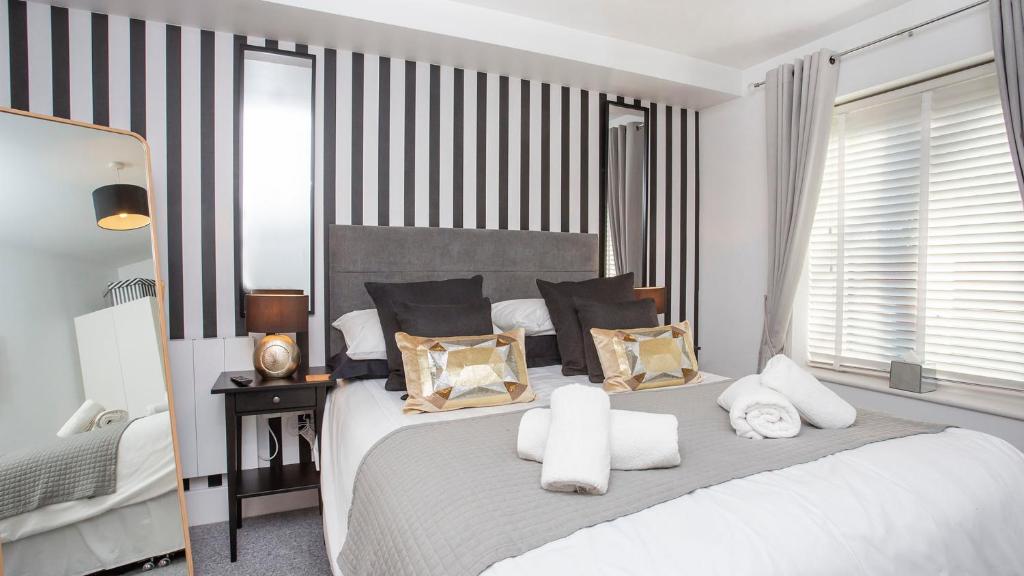 a bedroom with a large white bed with pillows at The Abbots Chambers in York