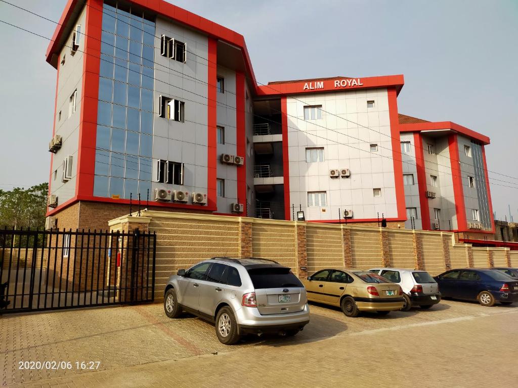 a group of cars parked in front of a building at Alim Royal Hotel and Suite in Abuja