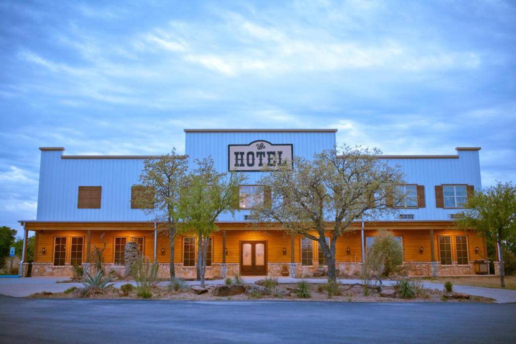a building with a hotel sign on top of it at Wildcatter Ranch and Resort in Graham