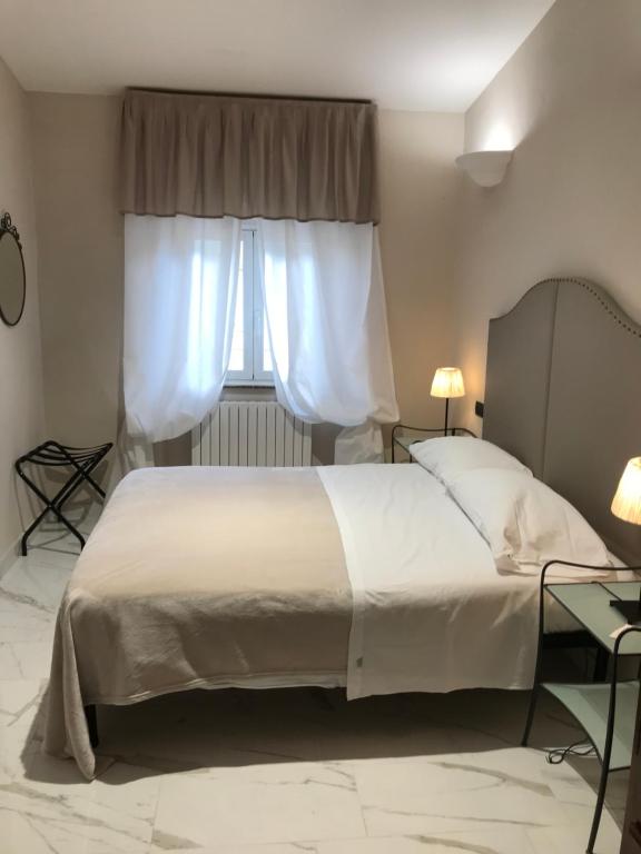 Postel nebo postele na pokoji v ubytování Hotel Paola
