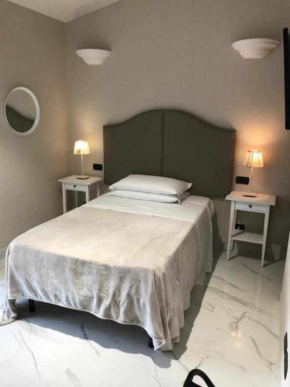 Postel nebo postele na pokoji v ubytování Hotel Paola