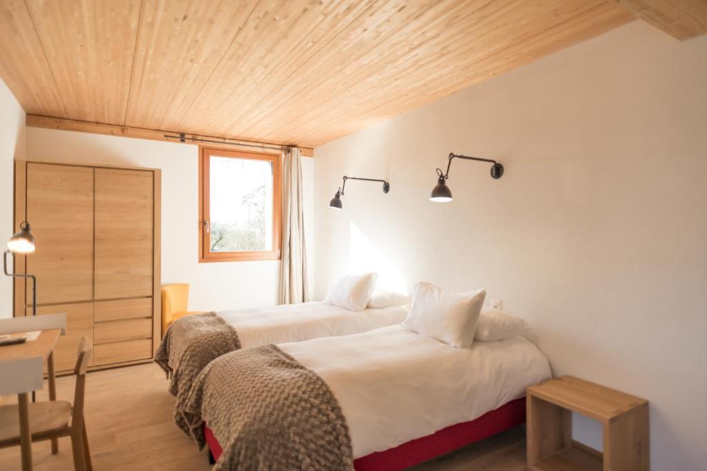 Postel nebo postele na pokoji v ubytování La Ferme du Lignon