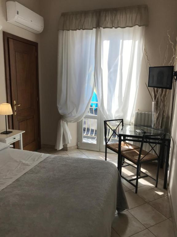 Postel nebo postele na pokoji v ubytování Hotel Paola